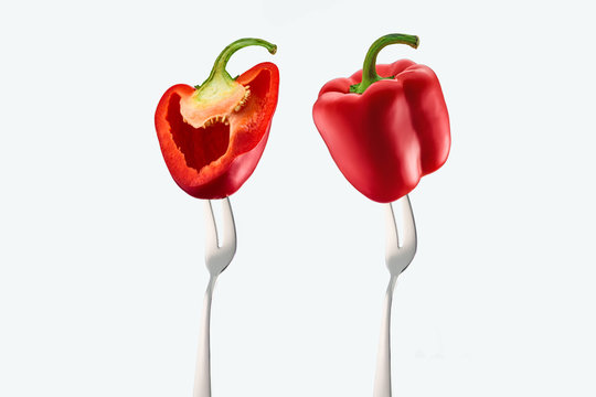 cut and whole red bell peppers on forks isolated on white © LIGHTFIELD STUDIOS