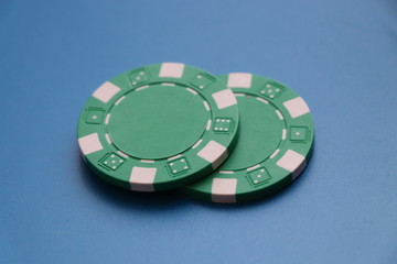 A two green tokens for playing roullete or some poker