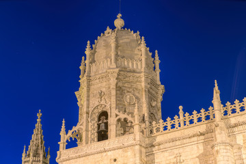 Fototapeta premium Facade of the Jeronimos (Hieronymites) Monastery in the Belem district of Lisbon illuminated at night