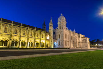 Fototapeta na wymiar Facade of the Jeronimos (Hieronymites) Monastery in the Belem district of Lisbon illuminated at night