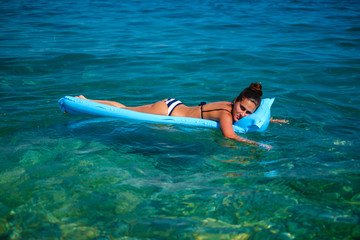 Girl smiling while resting on a floating bed
