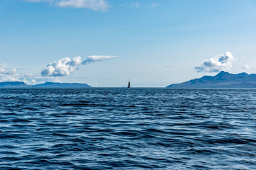 Sailboat sailing toward the Isles of Eigg and Rum  as seen from the Isle of Skye , Scotland