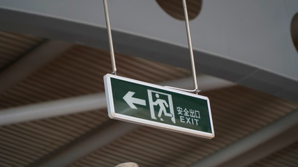 Exit Sign with roof background inside the building