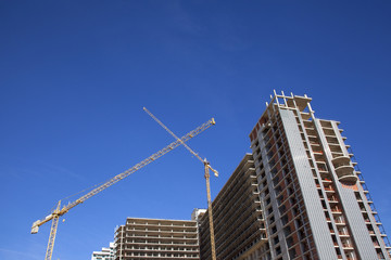 Fototapeta na wymiar Construction of a high-rise building. Lifting cranes.