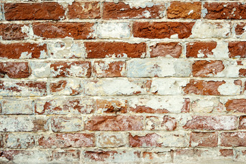 Old brick wall. Grunge background. Shabby Building Facade With Damaged Plaster.