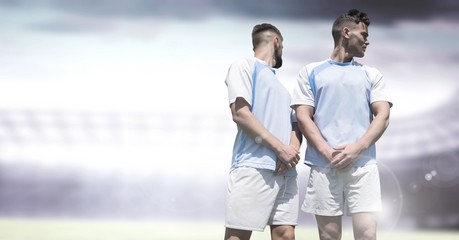 Soccer players in stadium light free kick wall