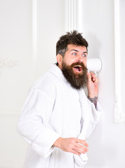 Hipster in bathrobe on surprised face secretly listen conversation. Secret and spy concept. Man in...
