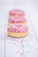 pink donuts on wooden table