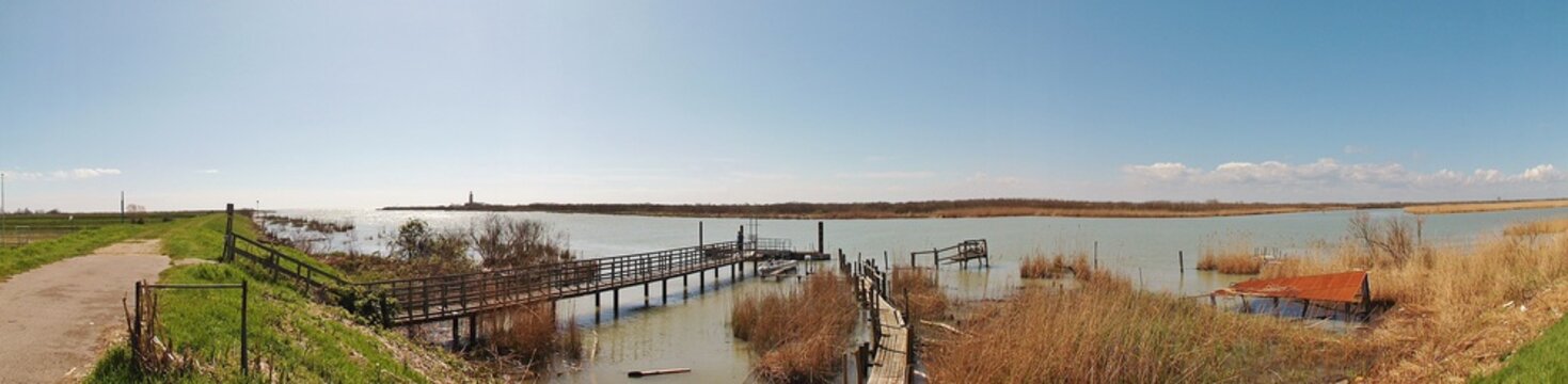 Panorama picture of the Delta del Po, a natural paradise. An arm of the Po river, Po di  Goro, flows into the Adriatic sea. Italy, Veneto region, Europe.
