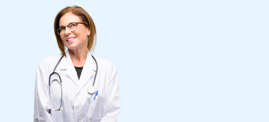 Doctor woman, medical professional thinking and looking up expressing doubt and wonder isolated blue background