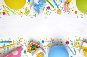 Birthday party caps, blowers, gifts, colorful balloons, serpentine and confetti on white...