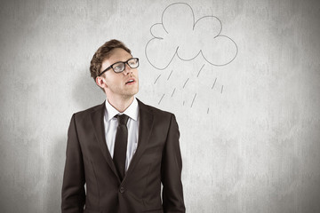 Young businessman thinking and looking up against white background