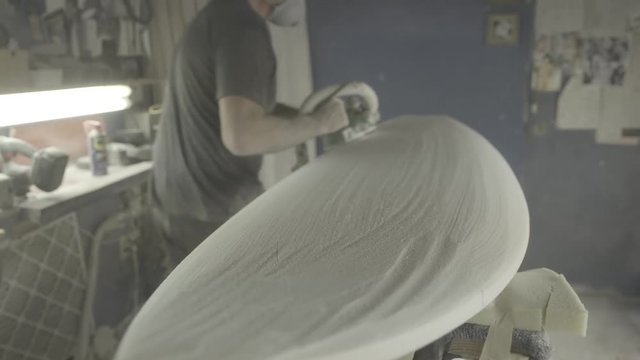 Man Shaping Surfboard