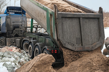 the truck pours the sand