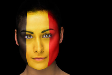 Composite image of belgian football fan in face paint against black