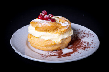 Zeppole with pastry cream on a plate