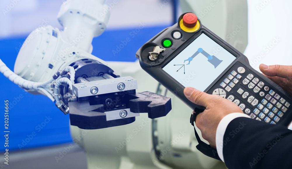 Aufkleber Engineer with teach pendant device. Programming robot with robotic arm. Smart factory 