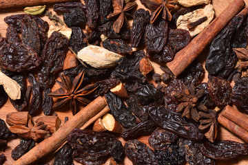 Seasoning and ingredients for mulled wine on a wooden surface. Ingredients for mulled wine