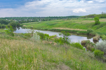 Fototapeta na wymiar Spring landscape with small lake near Zeleny Gai village near Dnipro city, Ukraine