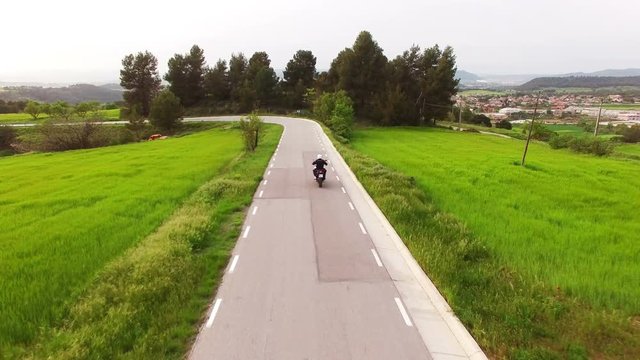 Motorcyclist Driving his Enduro Motorbike on a Curvy Road.
Aerial drone shot of a young man with his sports motorbike in spring.
Cross motorcycle in action on a scenic road in Catalonia.