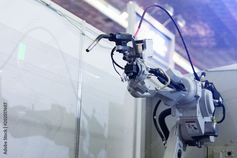 Leinwandbilder Automatic welding robot in a modern factory in operation. 