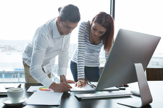 Man and woman working in office