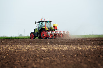 Farmer seeding crops at field