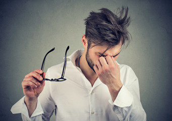 man with glasses suffering from eyestrain