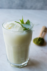 Iced Matcha Tea Latte with Mint Leaves / Smoothie.