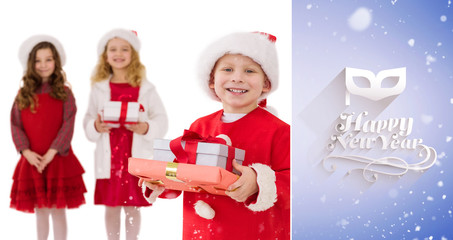 Festive little siblings smiling at camera holding gifts against purple vignette