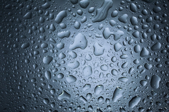 Water drops on dark wall and light, water drop for background and design.