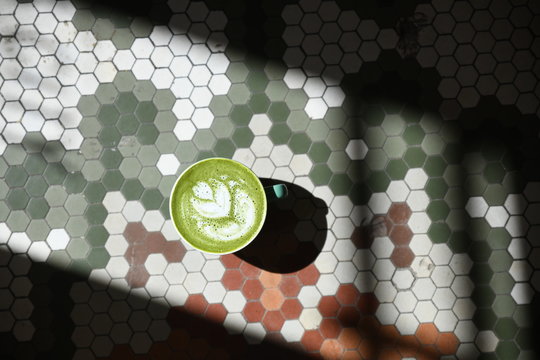 Matcha latte on tile background