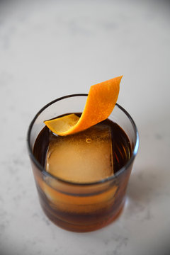 Cocktail with orange peel garnish