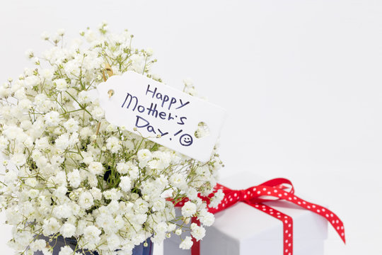 Bouquet of white baby's-breath flowers, "Happy Mother's day" note and gift box.