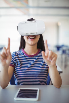 Schoolgirl Using Virtual Reality Headset In Classroom