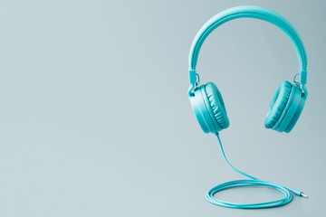 Bright blue headphones on gray