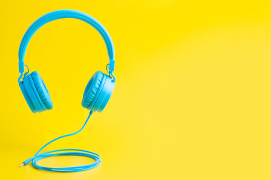 Bright blue headphones on yellow