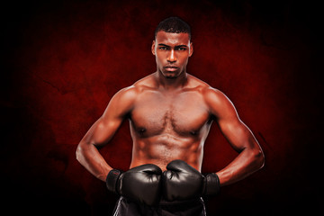 Fototapeta na wymiar Muscular boxer against dark background