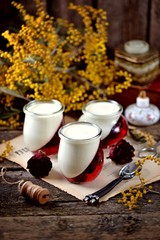 Traditional Italian dessert panna cotta with cherry jelly. Rustic style.