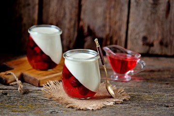 Traditional Italian dessert panna cotta with cherry jelly. Rustic style.