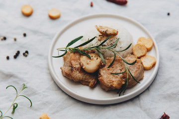 Close up  grilled meat solomillo with rise on linen tablecloth. Top view, flat lay