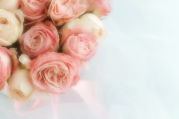 Blur effect, soft focus flowers background with bouquet of pale pink  roses on the white linen fabric background .Beautiful Holiday background.copy space.