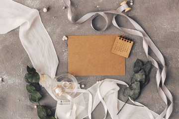 Wedding concept. Invitation on a grey background with decorations. Top view, flat lay