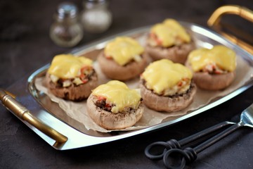 Champignons stuffed with vegetables and cheese.