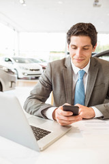 Smiling salesman having a phone call