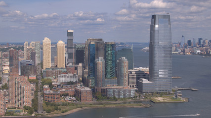 Fototapeta na wymiar AERIAL: Flying around New Jersey downtown skyscrapers overlooking NY Manhattan