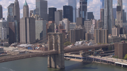 Fototapeta na wymiar AERIAL: Famous Brooklyn Bridge against Lower Manhattan downtown cityscape