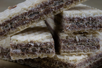 Tasty chocolate wafers. Sweet dessert cookies on a wooden kitchen table.