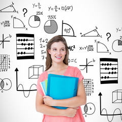 Smiling hipster holding notebook  against math