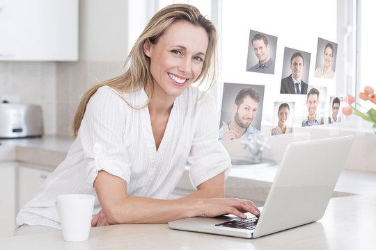 Happy woman using laptop at counter against profile pictures